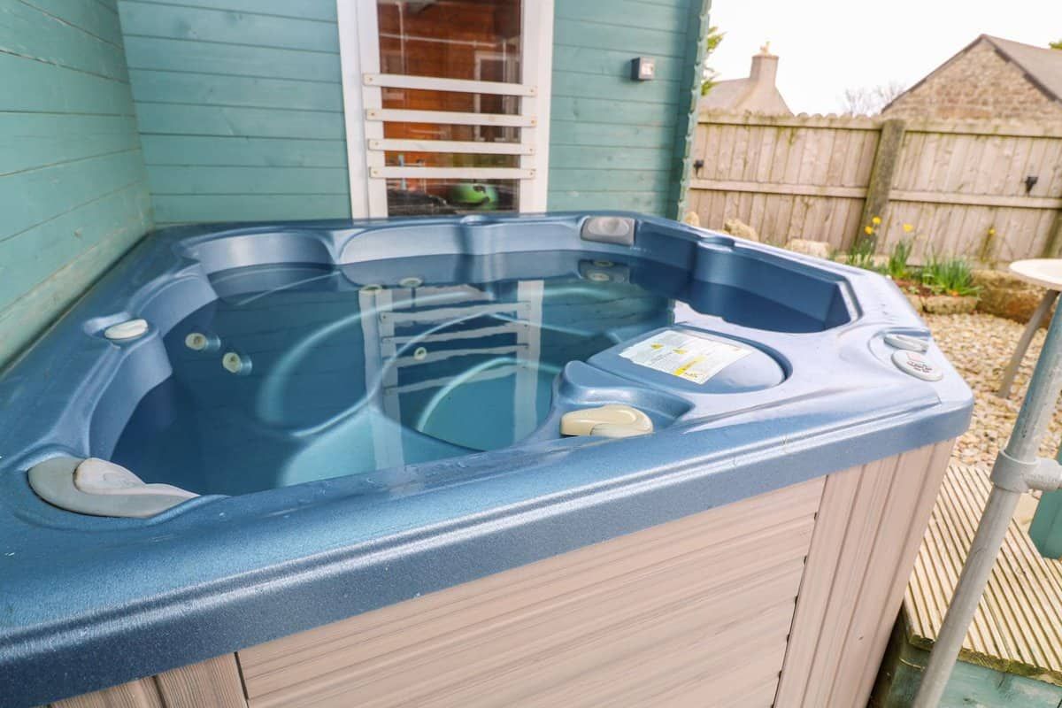 Relaxing outdoor hot tub surrounded by nature at Borah Lodge