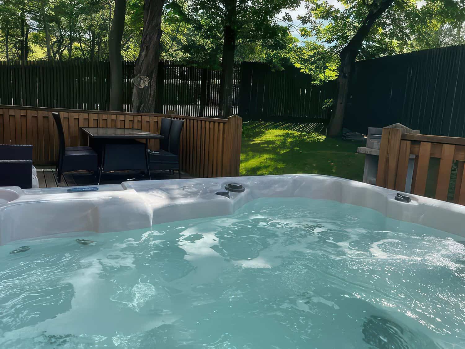 Hot tub on enclosed deck ideal for dog owners at pet-friendly Dovestone Lodge
