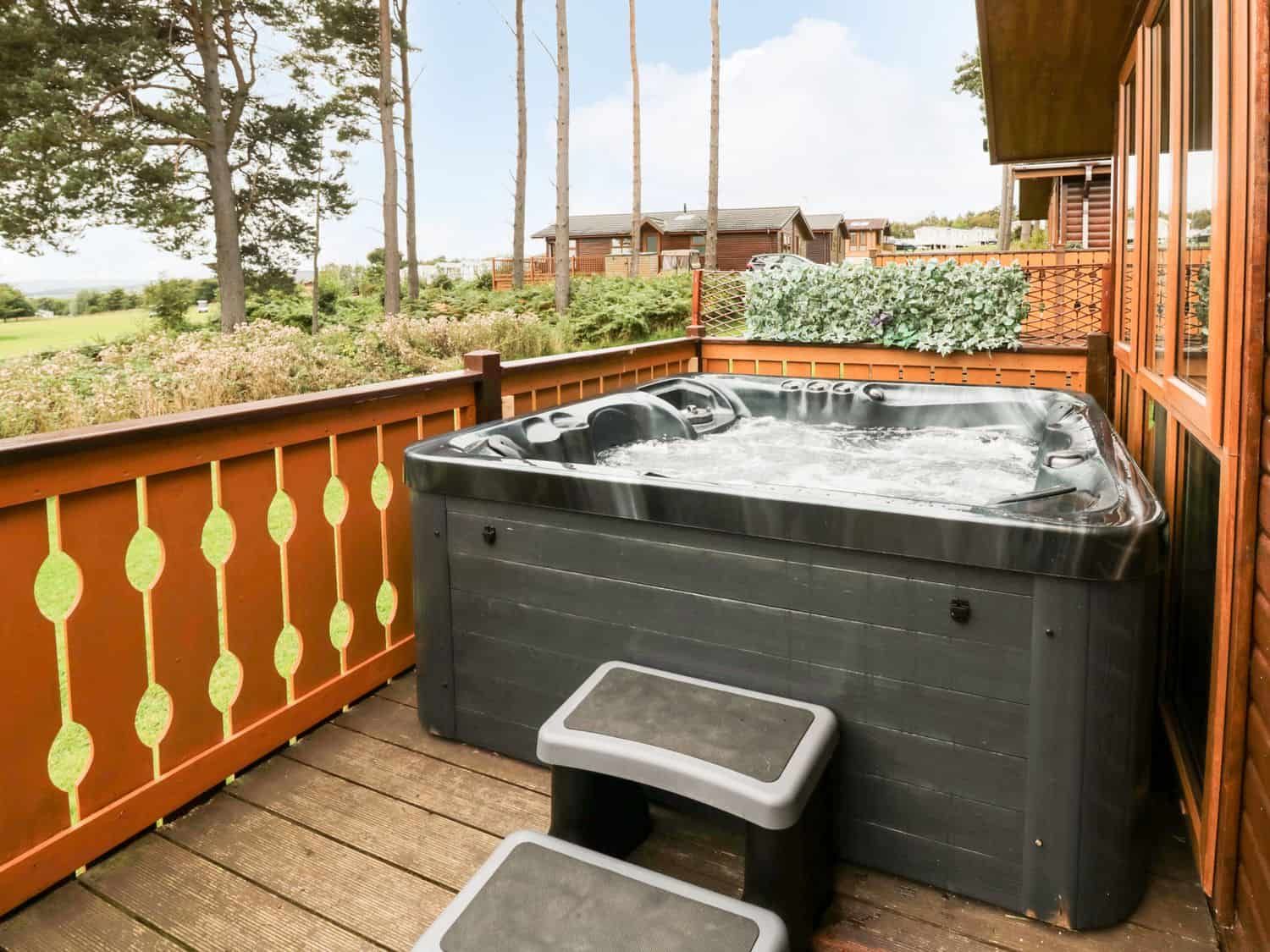 Private hot tub on deck with golf course views at Hillside View