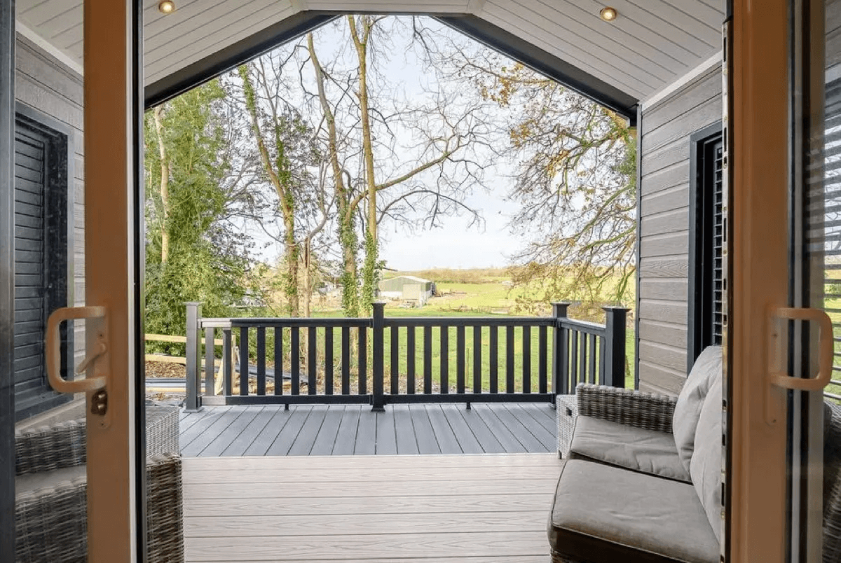 Private hot tub on wooden deck at Woodpecker Lodge