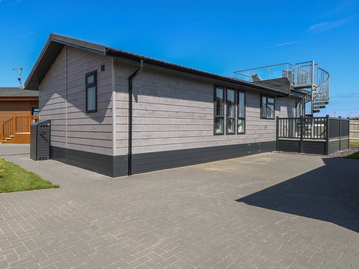 Life's a Beach coastal lodge with spiral staircase to rooftop terrace at Bacton