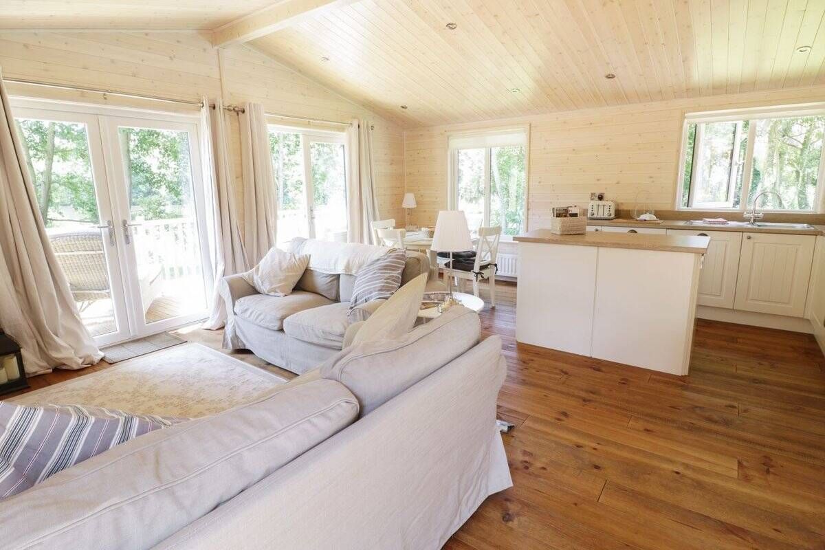 Open plan living room with comfortable sofas and dining area at Skylark