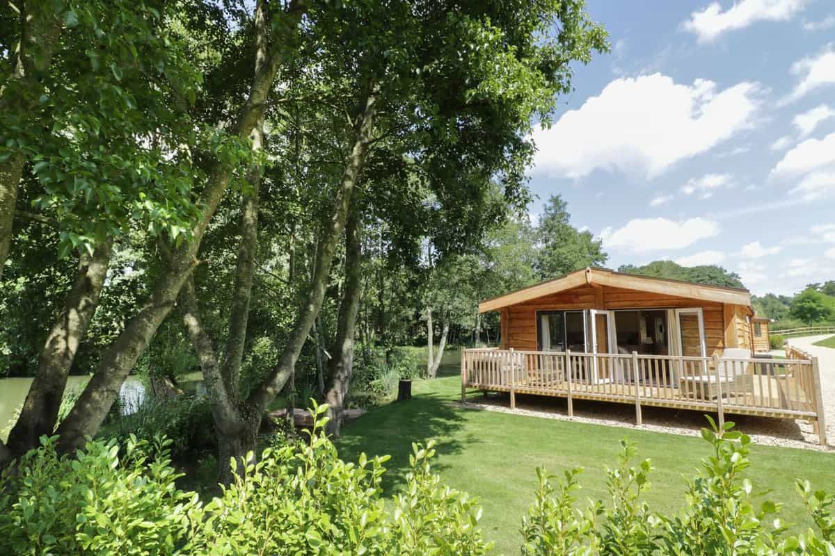Skylark log cabin with wooden deck overlooking fishing lake at Ross-on-Wye