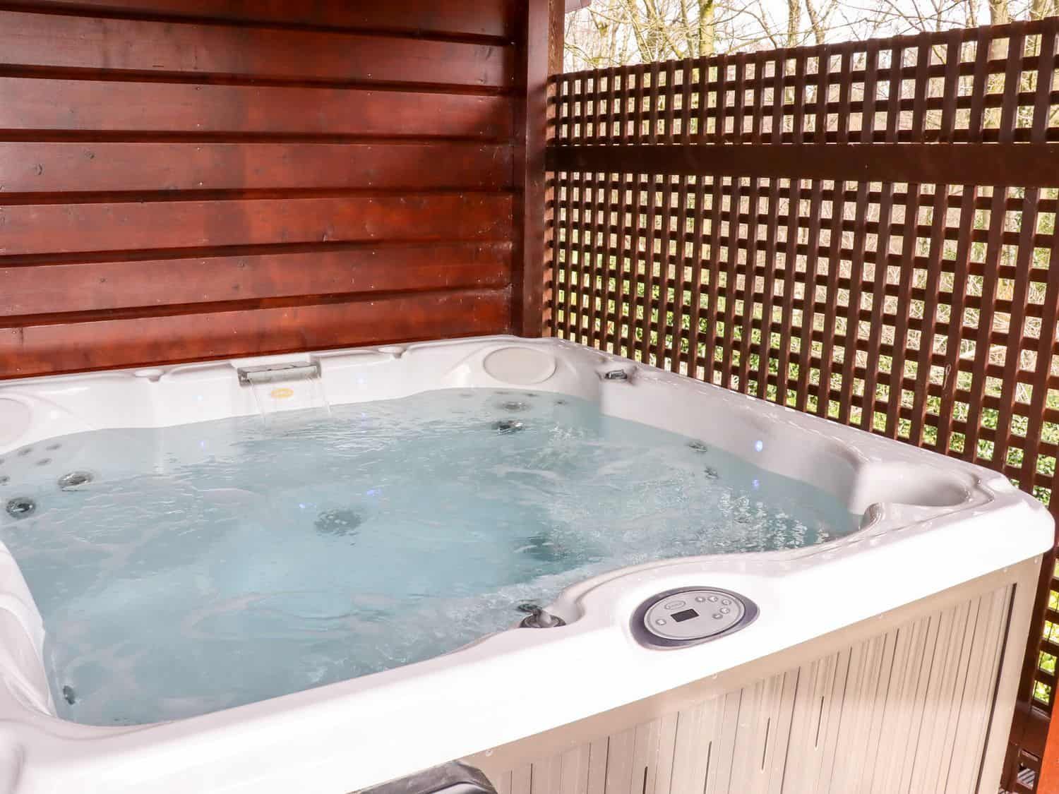 Private hot tub on enclosed deck with lake views at Watersview Lodge Rudyard
