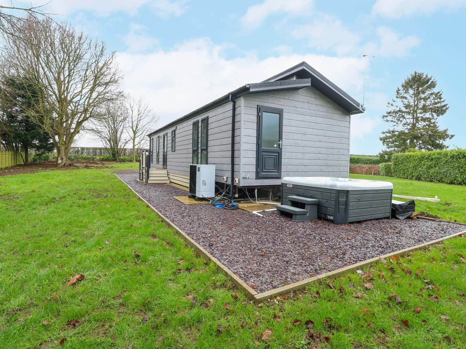 Wurzburc lodge exterior with private hot tub on gravel terrace