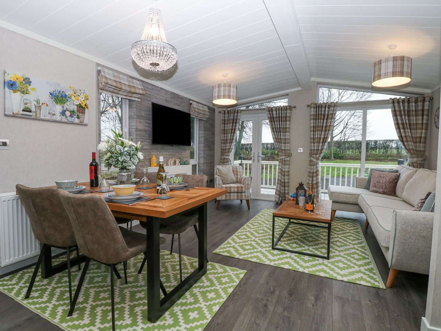 Dining and living area with wooden table set for dinner at Wurzburc